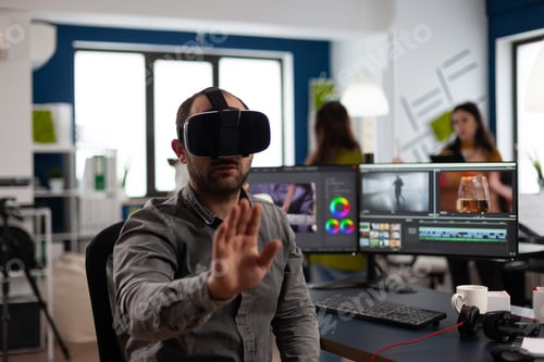 Preview: Video editor experiencing virtual reality headset, gesturing, editing film montage