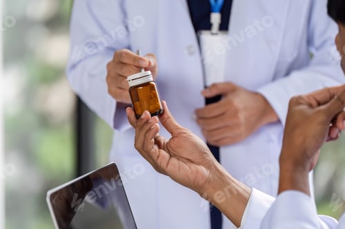 Preview: Doctor handing over prescription medication to a colleague for consultation