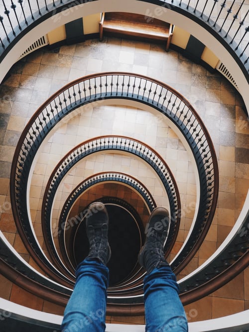 Preview: picture of legs dangling from tall spiral building