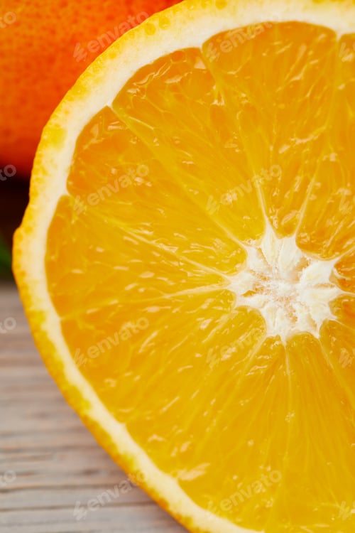 Preview: close-up shot of half of orange on wooden surface