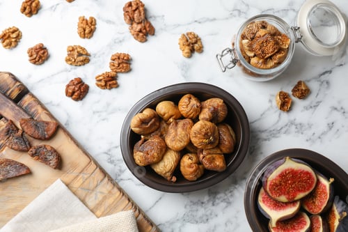 Preview: Flat lay composition with walnuts, fresh and dried figs on marble background