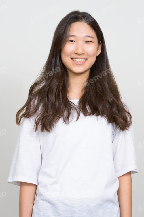 Preview: Portrait of happy young beautiful Asian woman smiling