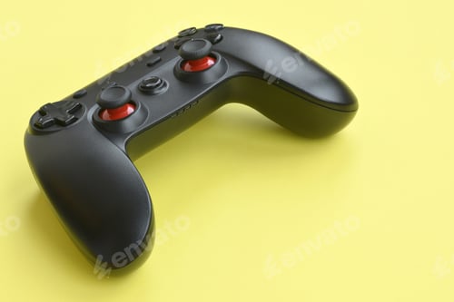 Preview: Modern black video game controller on yellow background