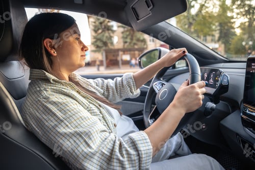 Preview: Young woman driving a car. Hands on the wheel. Young woman on the road by car.