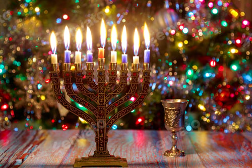 Preview: Hanukkah background with menorah and burning candles on sparkle background with defocused lights.