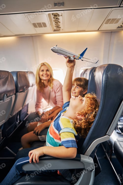 Preview: Boy raising a toy aircraft over his head