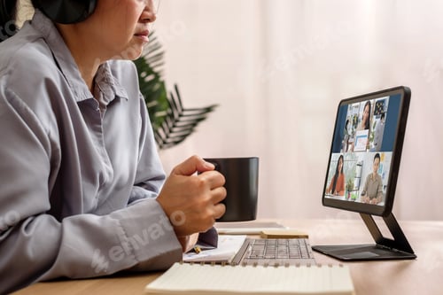 Preview: asian woman video conference business meeting with colleage online with tablet at home