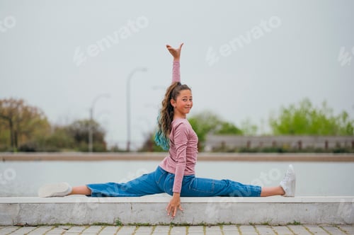 Preview: Portrait of a girl doing rhythmic gymnastics outdoors.