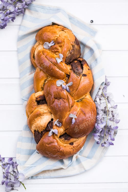 Preview: Tsoureki traditional baked Greek Easter sweet bread. Easter time, springtime. Holiday food concept.