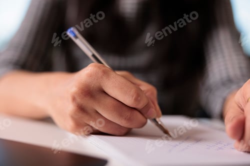 Preview: Office worker writing information on notebook