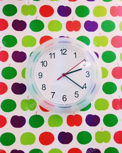 Preview: Fruity wallpaper behind a clock on the wall of a classroom in a private English school.