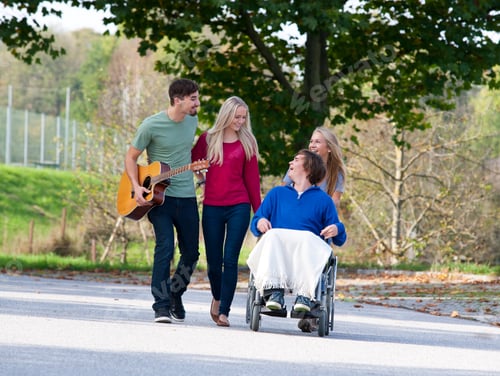 Preview: Young man in wheelchair with friends