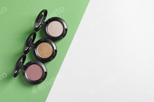 Preview: Flat lay composition with different eye shadows on color background. Space for text