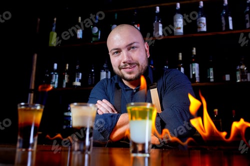 Preview: Fiery Show At The Bar. The Bartender Makes Hot Alcoholic Cocktail And Ignites Bar. Bartender