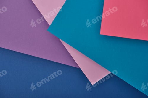 Preview: top view of purple, blue and pink paper sheets with copy space