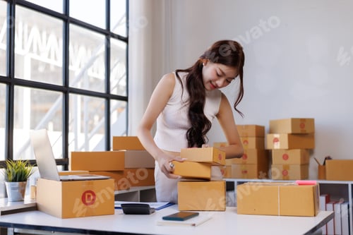 Preview: Woman working on online orders packing boxes