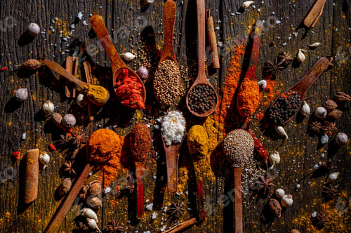 Preview: Colorful spices scattered across rustic wooden panels
