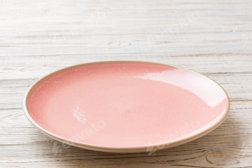 Preview: Perspective view of empty pink plate on wooden background. Empty space for your design