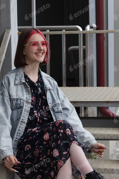 Preview: Girl with pink hair sitting on the stairs