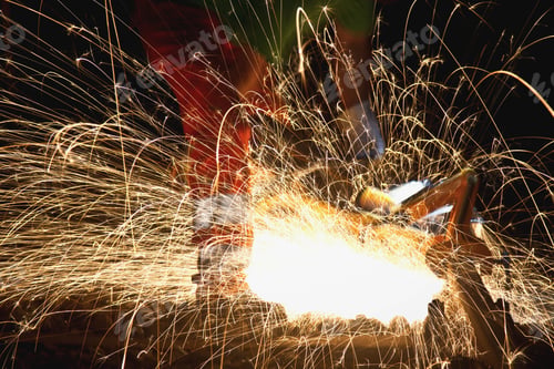 Preview: Anonymous man working with steel