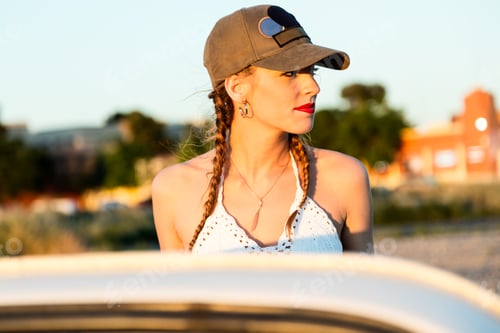 Preview: Pretty young woman driving on road trip on beautiful summer day.