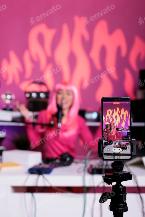 Preview: Content creator sitting at desk table talking into microphone with subscribers while filming vlog