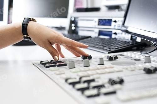 Preview: Hand Adjusting Audio Mixer in Studio Setting
