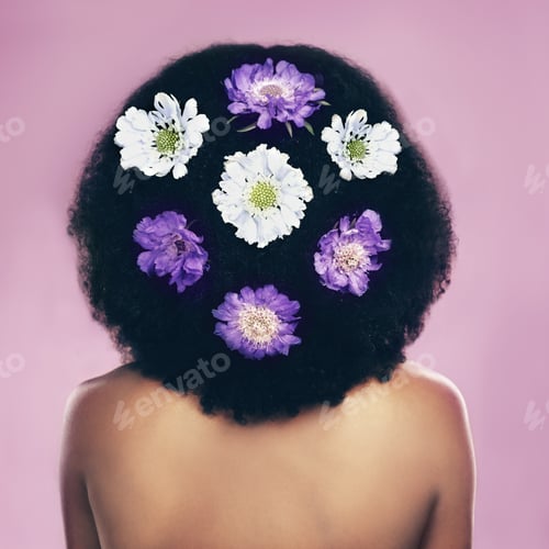 Preview: Flowers are everywhere. Rearview shot of a woman standing with flowers in her hair.