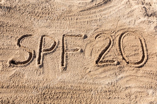 Preview: Sun protect factor twenty concept. SPF 20 word written on the beach