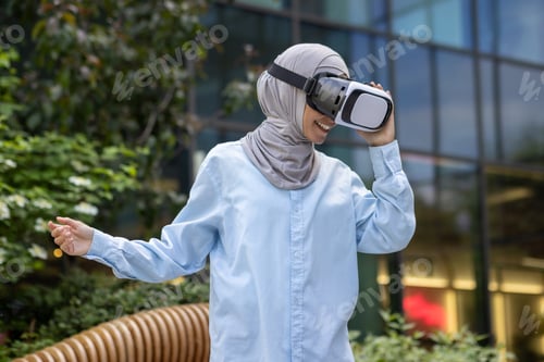 Preview: Muslim woman experiencing virtual reality outdoors