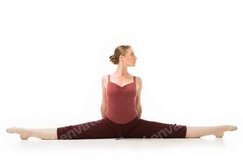 Preview: focused ballerina exercising and doing twine isolated on white background