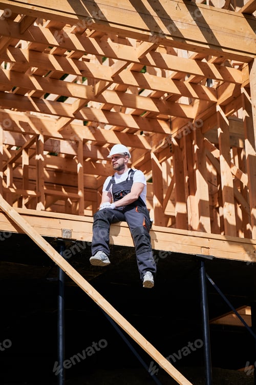 Preview: Carpenter constructing wooden frame house.