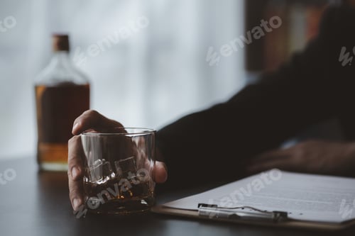Preview: A lawyer holding a glass of whiskey, He's in his office.