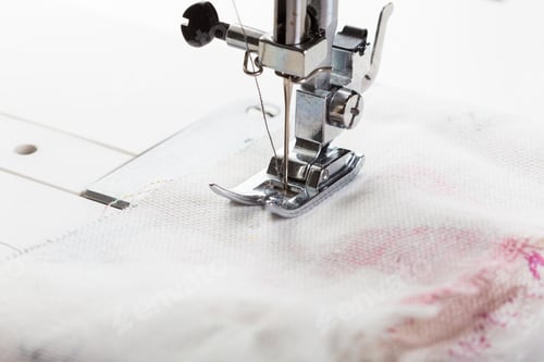 Preview: Sewing machine in action creating fabric stitches on a white cloth