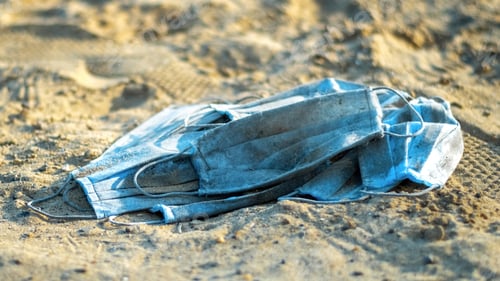 Preview: A bunch of medical masks on the beach of a lake