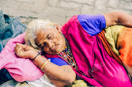 Preview: Woman sleeping peacefully on a bed with a pillow, outside in Mumbai, India