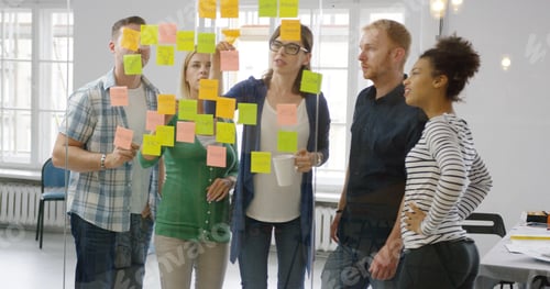 Preview: Colleagues working together in modern office