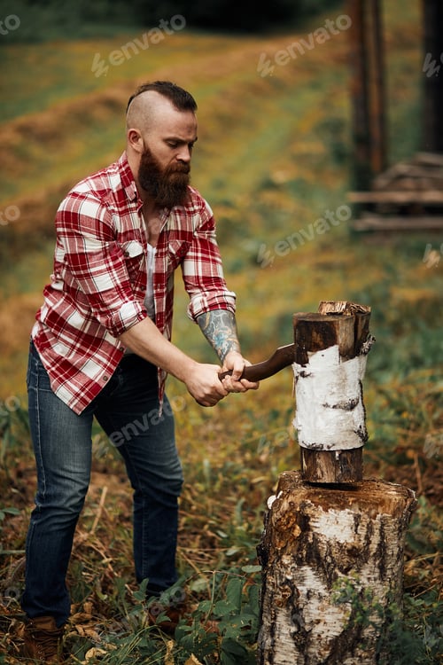Preview: Woodcutter in shirt chopping firewoods, chips fly apart