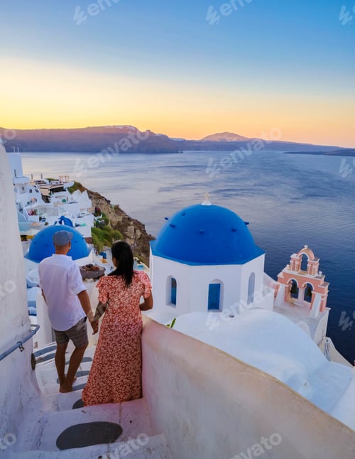 Preview: Couple on vacation in Santorini Greece, men and women at the streets of the Greek village of Oia