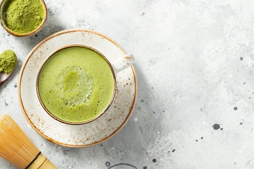 Preview: Matcha green tea latte in a cup with cream.