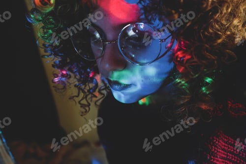 Preview: Young woman portrait illuminated by psychedelic lights