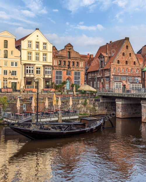 Preview: Vertical shot of the Pons and the riverfront buildings on a sunny day in Lueneburg, Germany