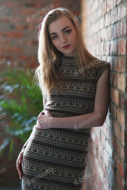Stylish Woman Posing Against Brick Wall Indoor