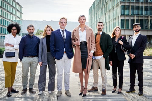 Preview: Multiracial business people standing outside financial district looking at camera with confident.
