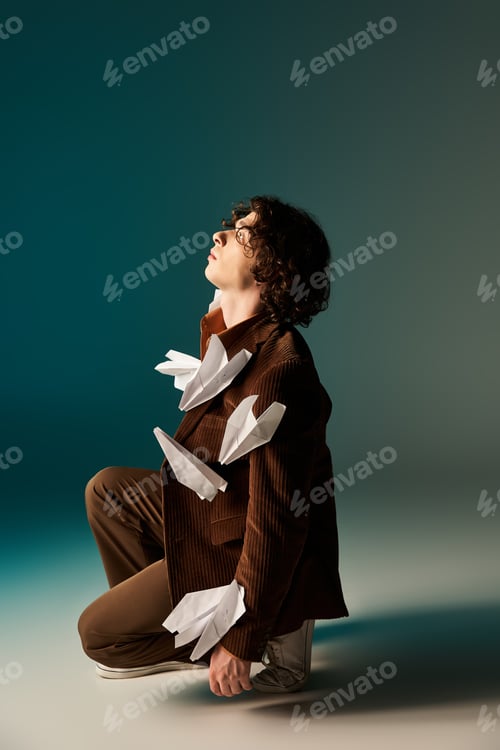 Preview: Stylish young man with paper planes in a creative studio setting
