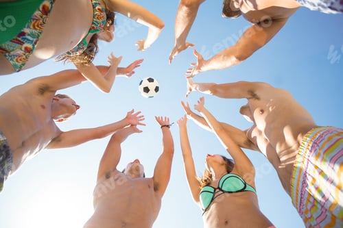 Preview: Friends throwing soccer ball in mid air