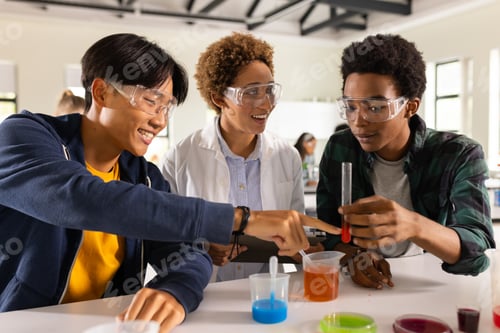 Preview: In high school, teenagers conducting science experiment with test tubes in classroom