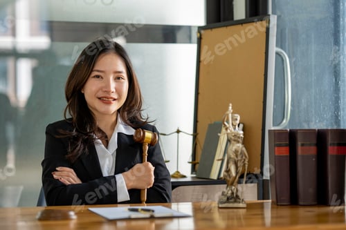Preview: Attractive young lawyer in office Business woman and lawyers discussing contract papers with brass s