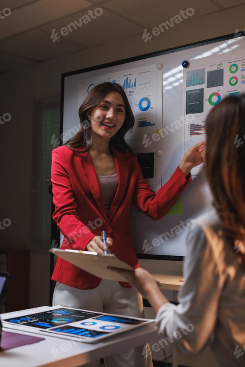 Preview: Businesswoman presenting data analysis strategy during late meeting