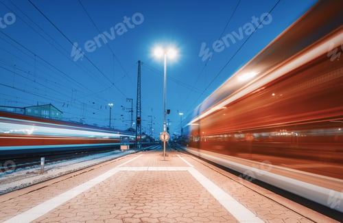 Preview: Two high speed trains in motion on the railway station at night